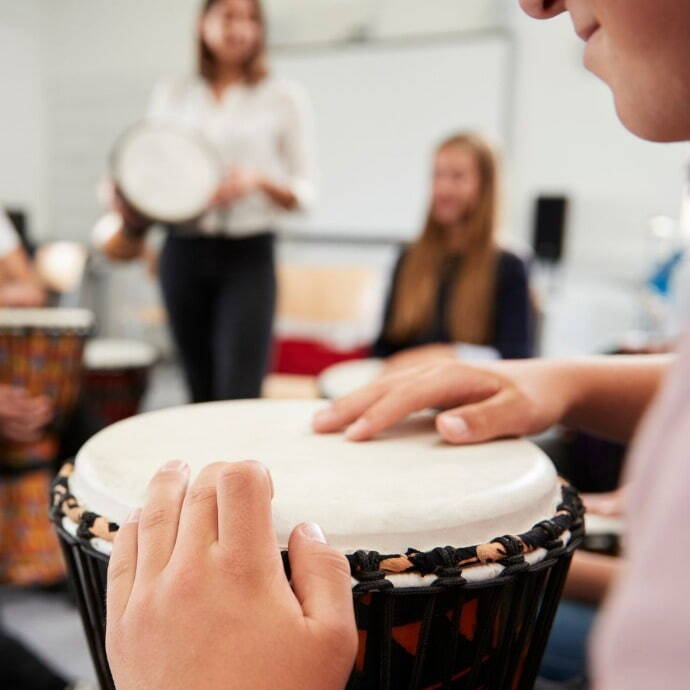 Children playing musical instruments in class